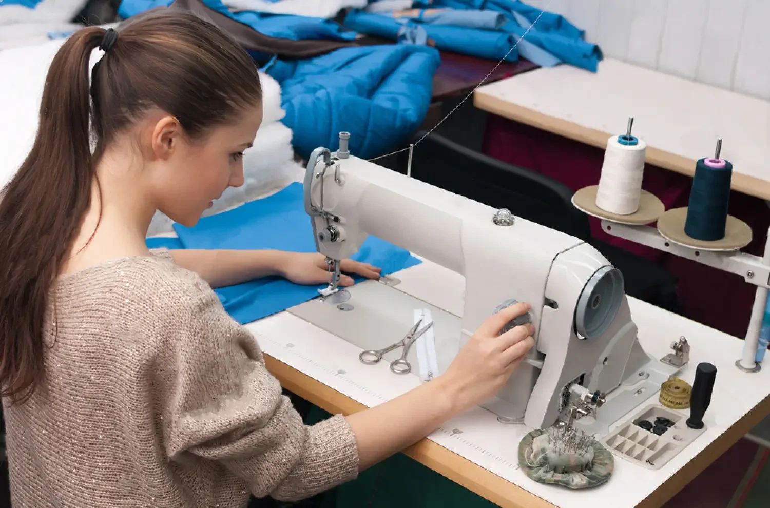stock-photo-she-sews-on-the-sewing-machine-125434193